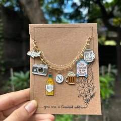 Travel Tales Neckpiece Travel Tales Neckpiece with flight, camera, and personalized initial charms Handcrafted Travel Tales Neckpiece