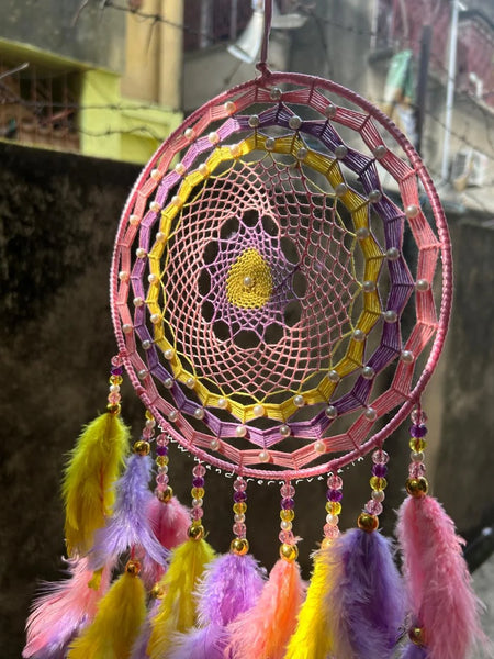 Blushing Sunrise Dreamcatcher in pink, lilac, and yellow Handcrafted Blushing Sunrise Dreamcatcher with white pearls Elegant Blushing Sunrise Dreamcatcher for home décor