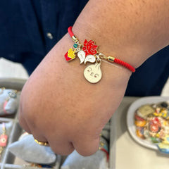 Red Adjustable Luxe Band featuring Fries, Ganesha and Modak charms.